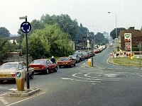 Traffic at the crossing. Franks garage, petrol 40p a litre. 1992